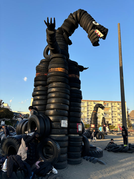 Retro shopping street and tire Godzilla park